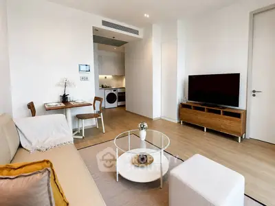 Modern living room with stylish furniture and open kitchen layout in a contemporary apartment.