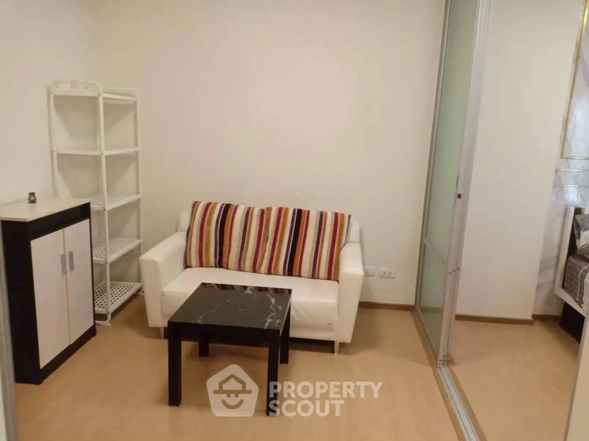 Cozy living room with modern decor and sliding glass door for a stylish urban apartment.