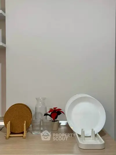 Modern kitchen countertop with dish rack and glassware, minimalist decor.