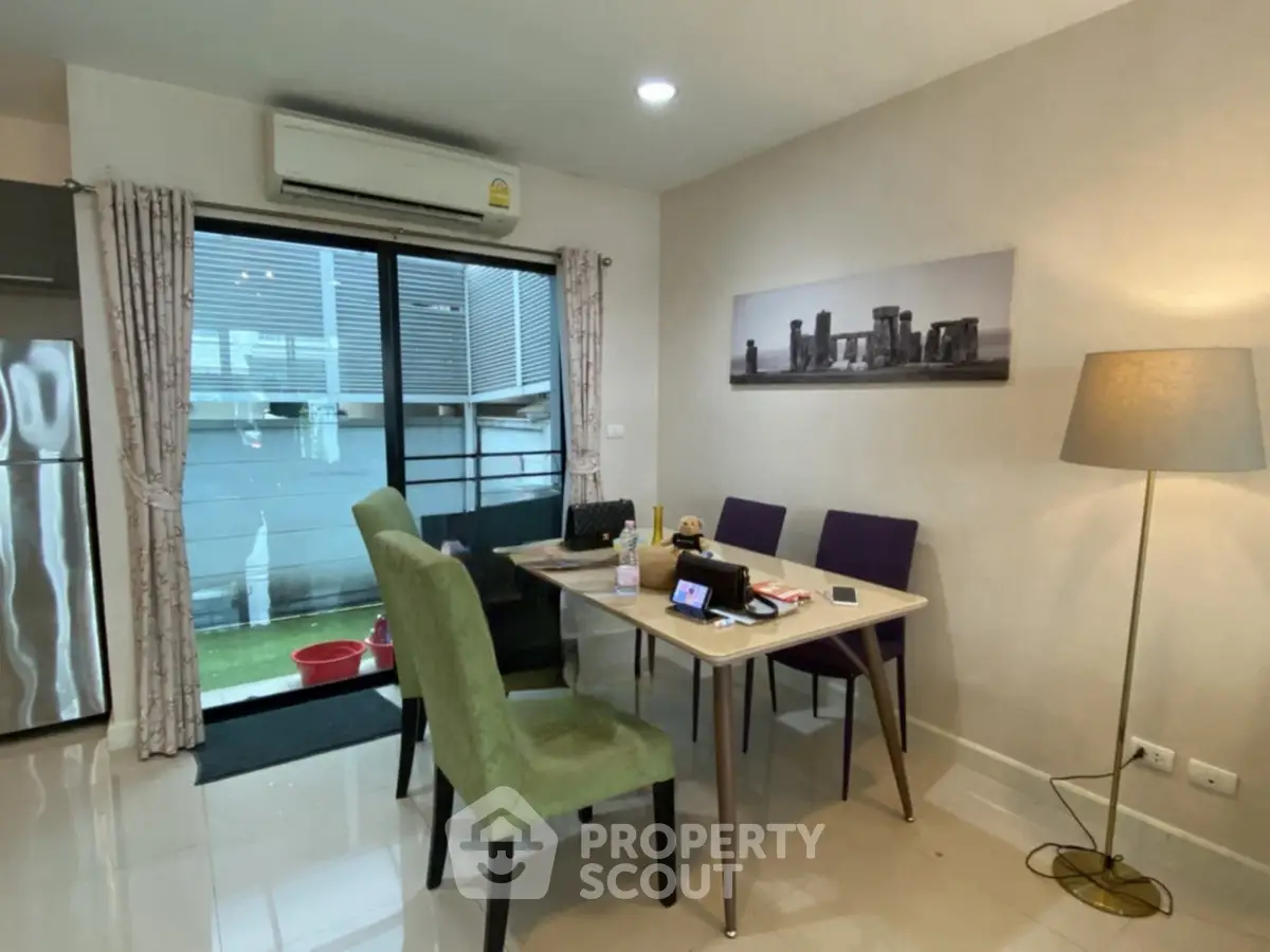 Modern dining area with stylish furniture and natural light in a cozy apartment.