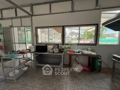 Spacious kitchen area with ample natural light and modern appliances
