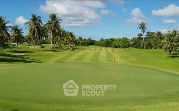Luxurious golf course view with lush greenery and palm trees, perfect for upscale real estate development.