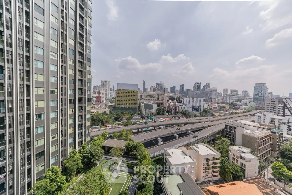 Stunning cityscape view from high-rise building with lush greenery and urban skyline.