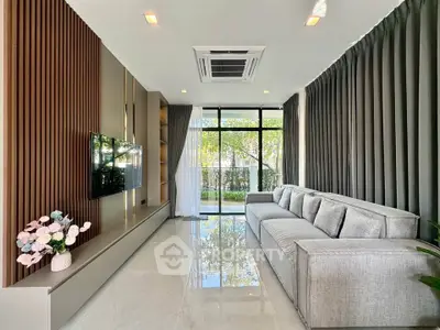 Modern living room with sleek design, large windows, and elegant decor