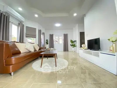 Spacious modern living room with elegant brown leather sofa and sleek TV unit, perfect for relaxation.