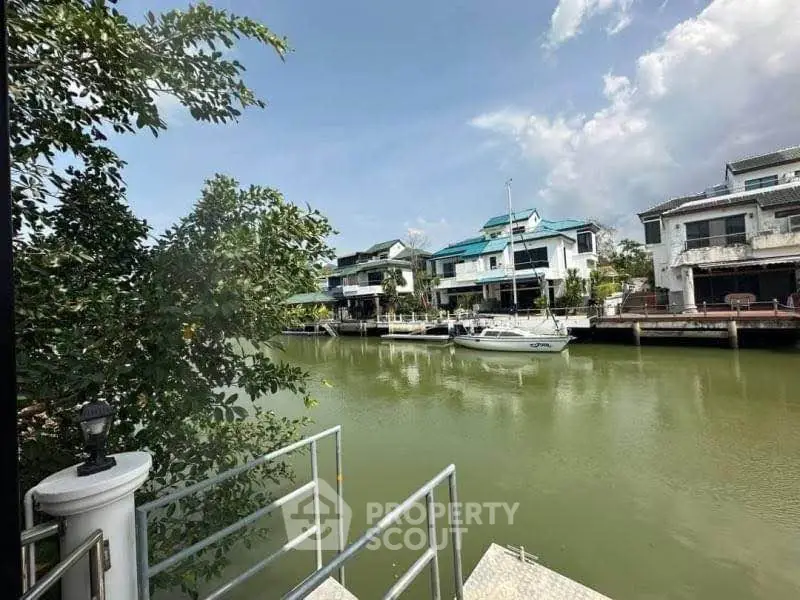 Stunning waterfront homes with private docks and lush greenery under a clear blue sky.