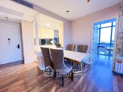 Modern dining area with elegant chairs and open kitchen layout