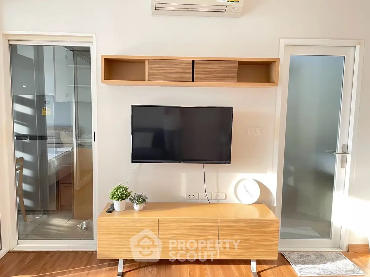 Modern living room with wall-mounted TV and stylish wooden furniture