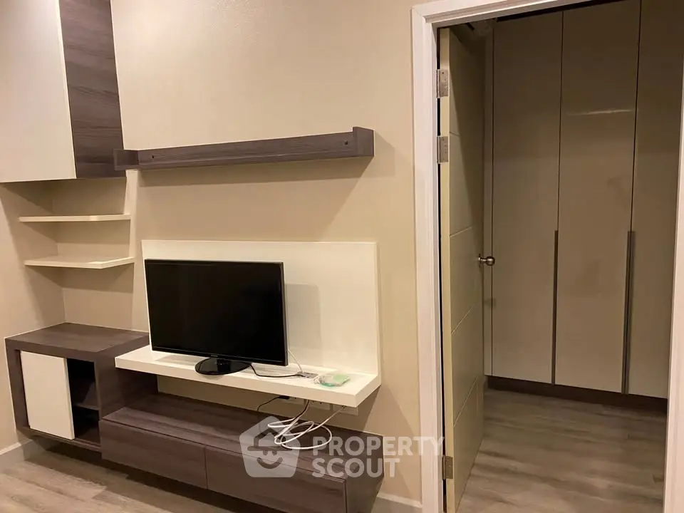 Modern living room with sleek TV unit and open closet space