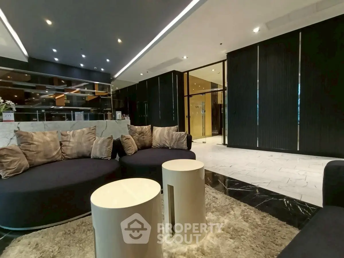 Luxurious modern lobby with plush seating and elegant decor in a high-end building.