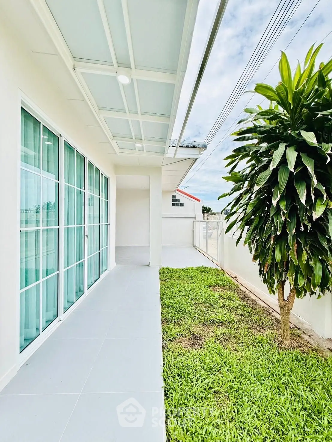 Modern home exterior with lush garden and large glass doors