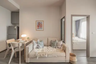 Modern apartment interior with cozy living room and adjacent bedroom, featuring stylish decor and natural lighting.