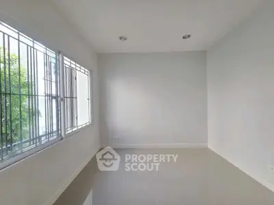 Spacious empty room with large window and glossy floor tiles