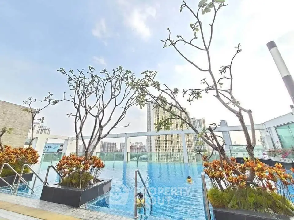 Stunning rooftop pool with city skyline views and lush greenery