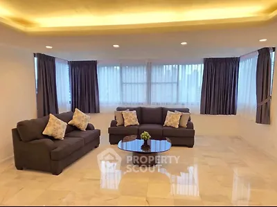 Spacious living room with elegant sofas and large windows