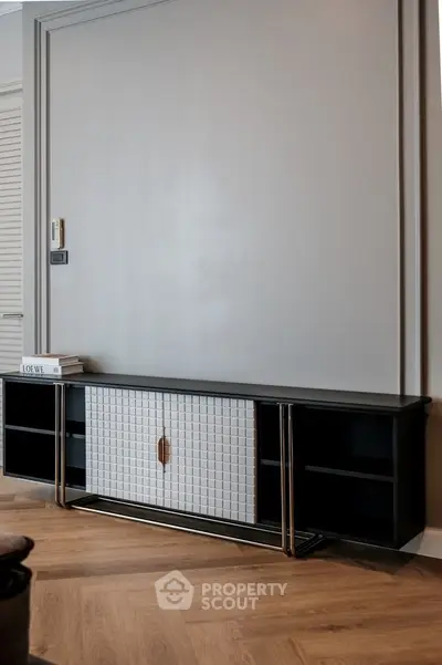 Modern interior with sleek console table and parquet flooring, perfect for stylish living room decor.