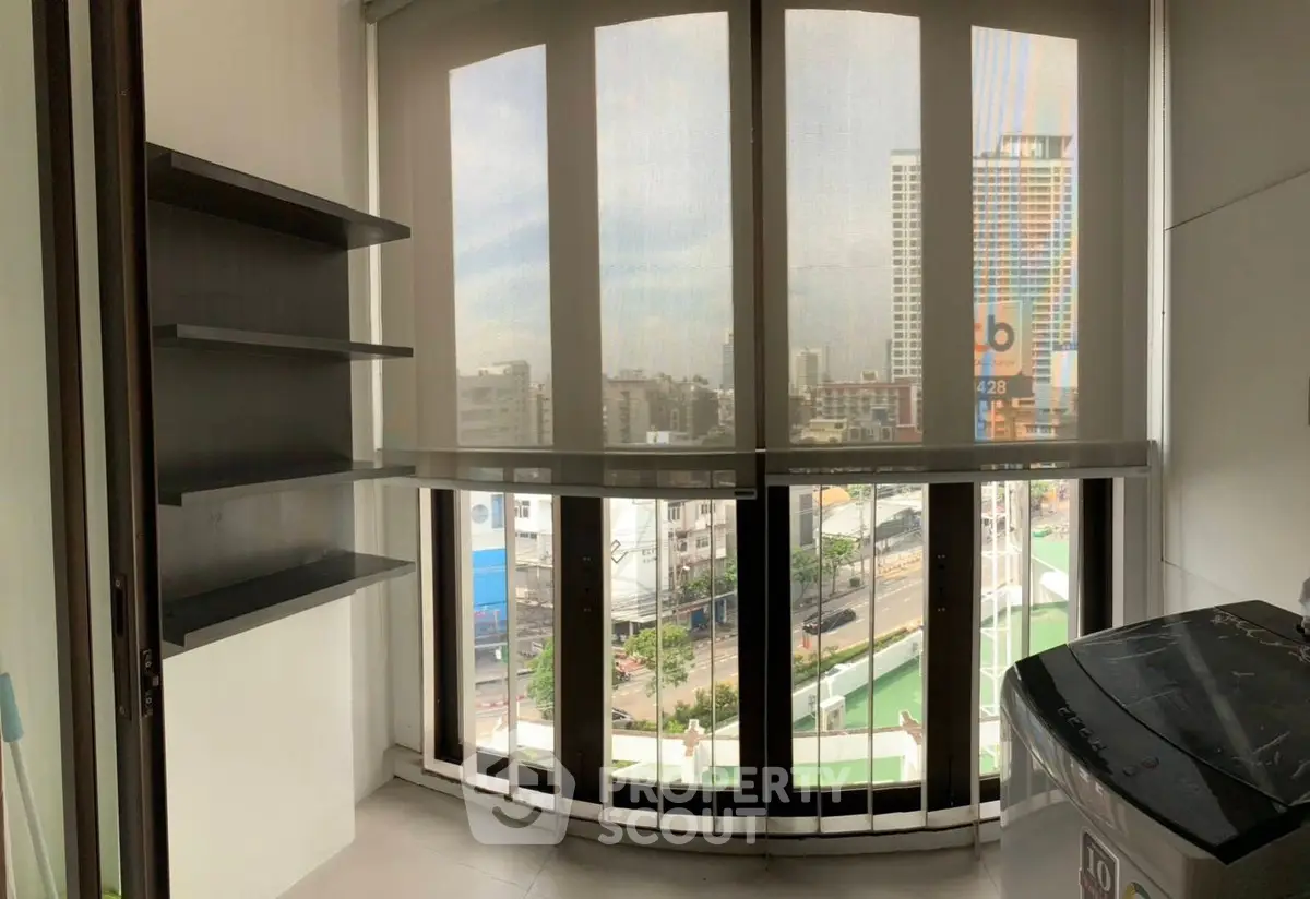 Compact balcony with city view and washing machine in modern apartment