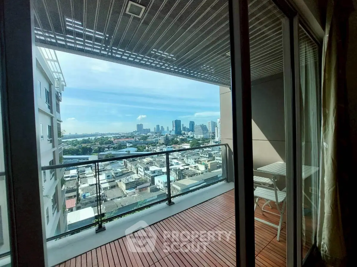 Stunning city view from spacious balcony with modern glass railing.