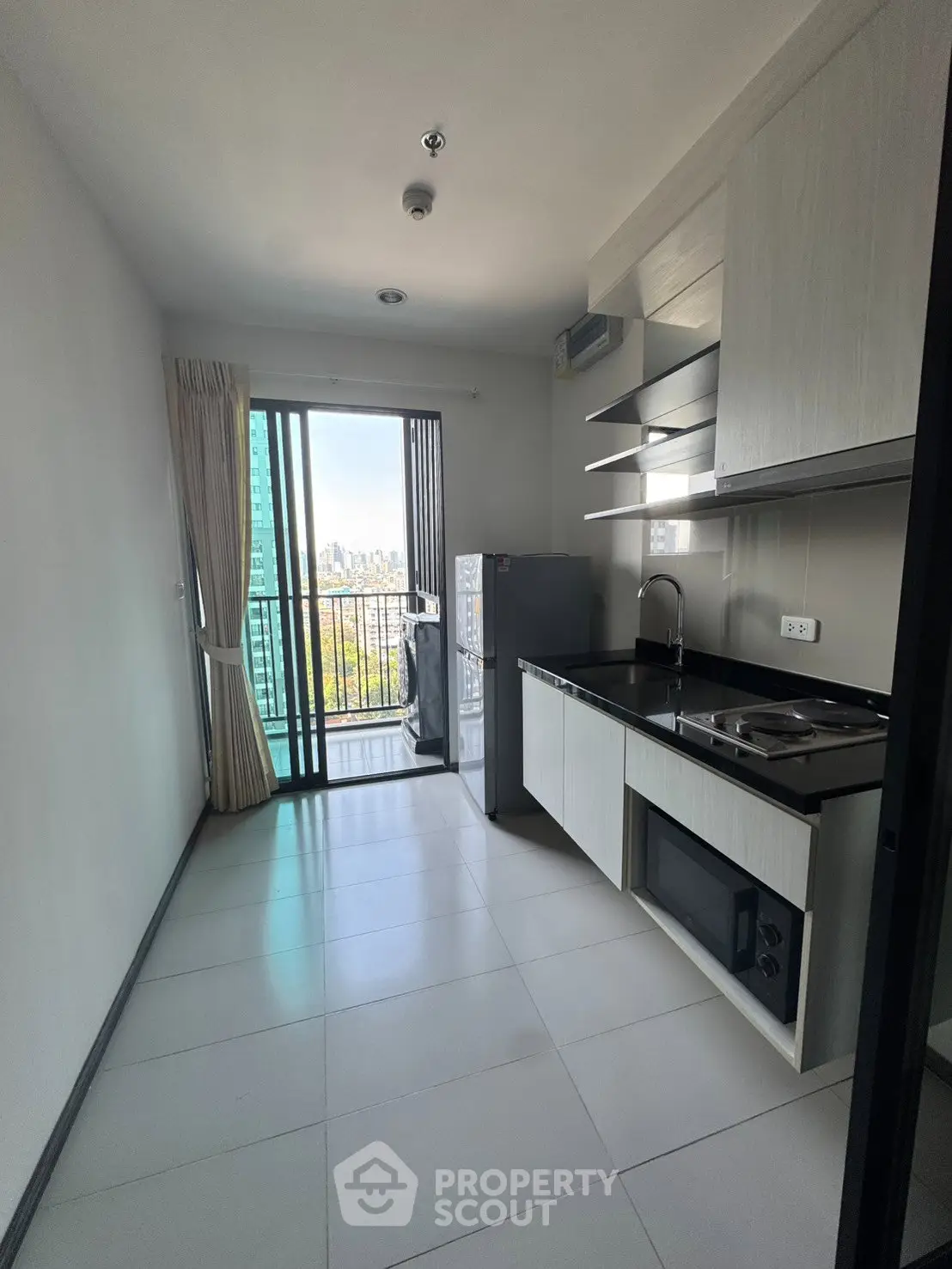 Modern kitchen with balcony view in high-rise apartment