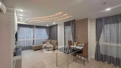 Modern living room with stylish ceiling lights and elegant dining area