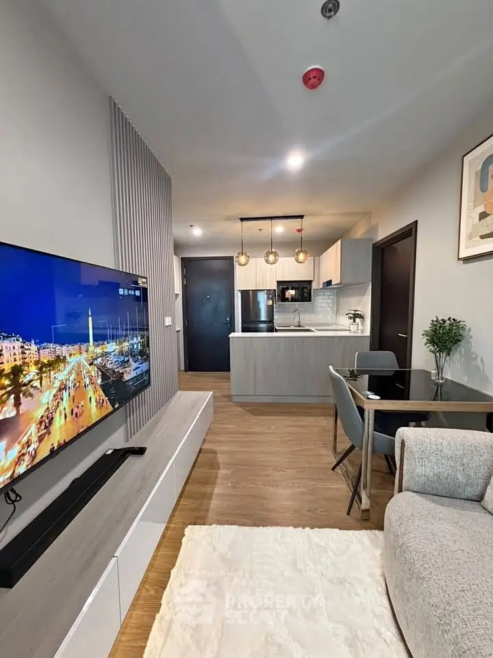 Modern open-layout living room with stylish kitchen and cozy seating area, perfect for urban living.