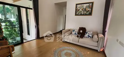 Charming living room with cozy sofa, large window, and stylish decor in a modern home.