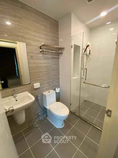 Modern bathroom with sleek fixtures and glass shower enclosure