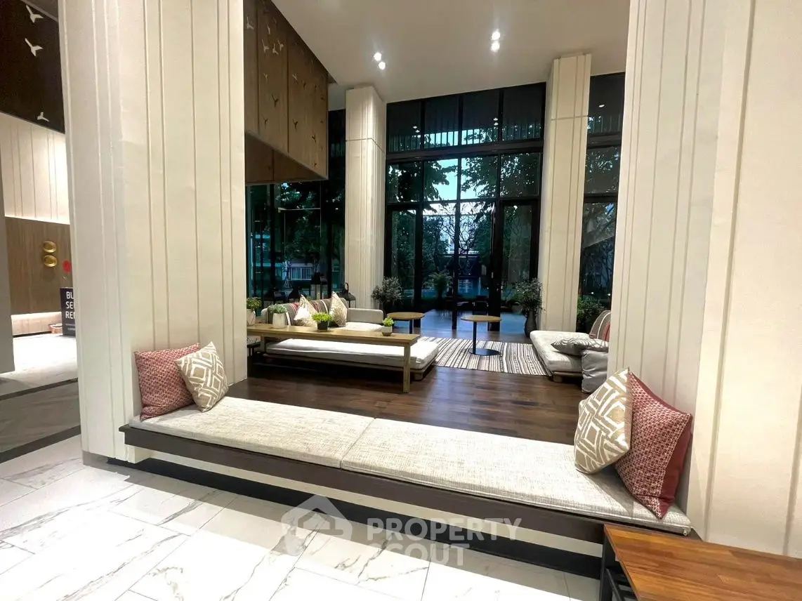 Luxurious modern living room with elegant decor and large windows overlooking a serene garden.