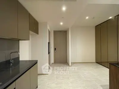 Modern kitchen with sleek cabinetry and stone countertops in a contemporary apartment.