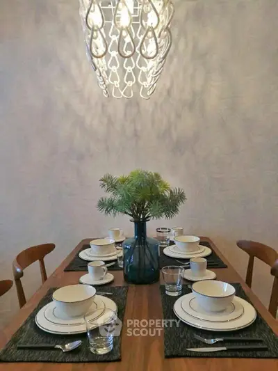 Elegant dining room with modern chandelier and stylish table setting