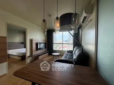 Modern living room with city view, stylish furniture, and natural light in a high-rise apartment.