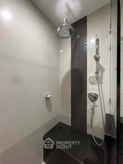 Modern bathroom shower with sleek black and white tile design