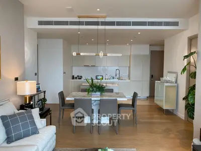 Modern open-layout kitchen and dining area with sleek design and elegant furnishings.