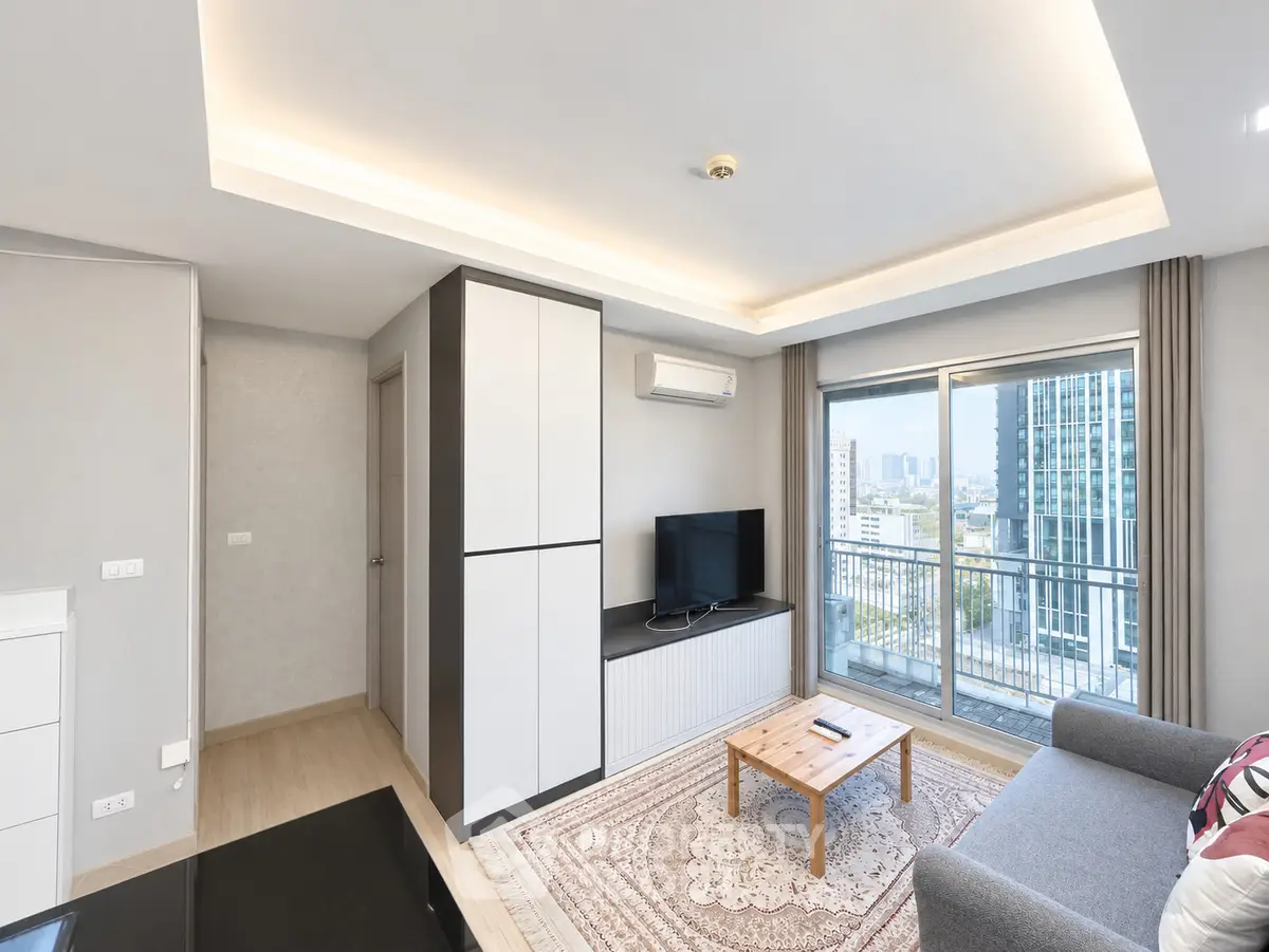 Modern living room with city view, stylish furniture, and natural light