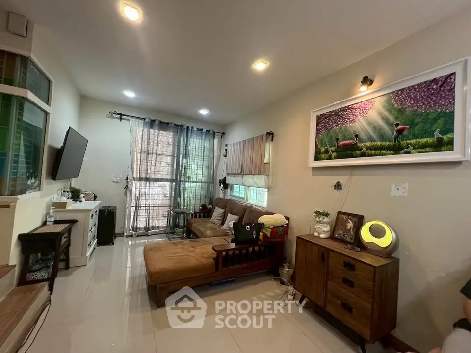 Cozy living room with modern decor and ample natural light, featuring a comfortable sofa and stylish furniture.