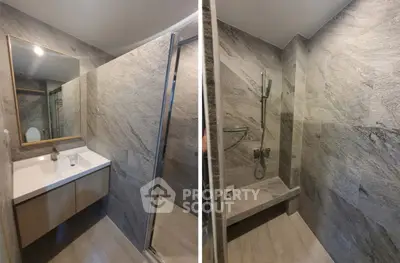 Modern bathroom with sleek stone tiles and spacious shower area