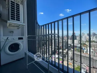 Stunning high-rise balcony with city skyline view and laundry area.