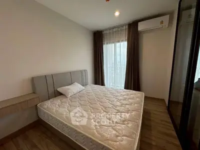 Modern bedroom with large window and minimalist design, featuring a comfortable bed and sleek flooring.