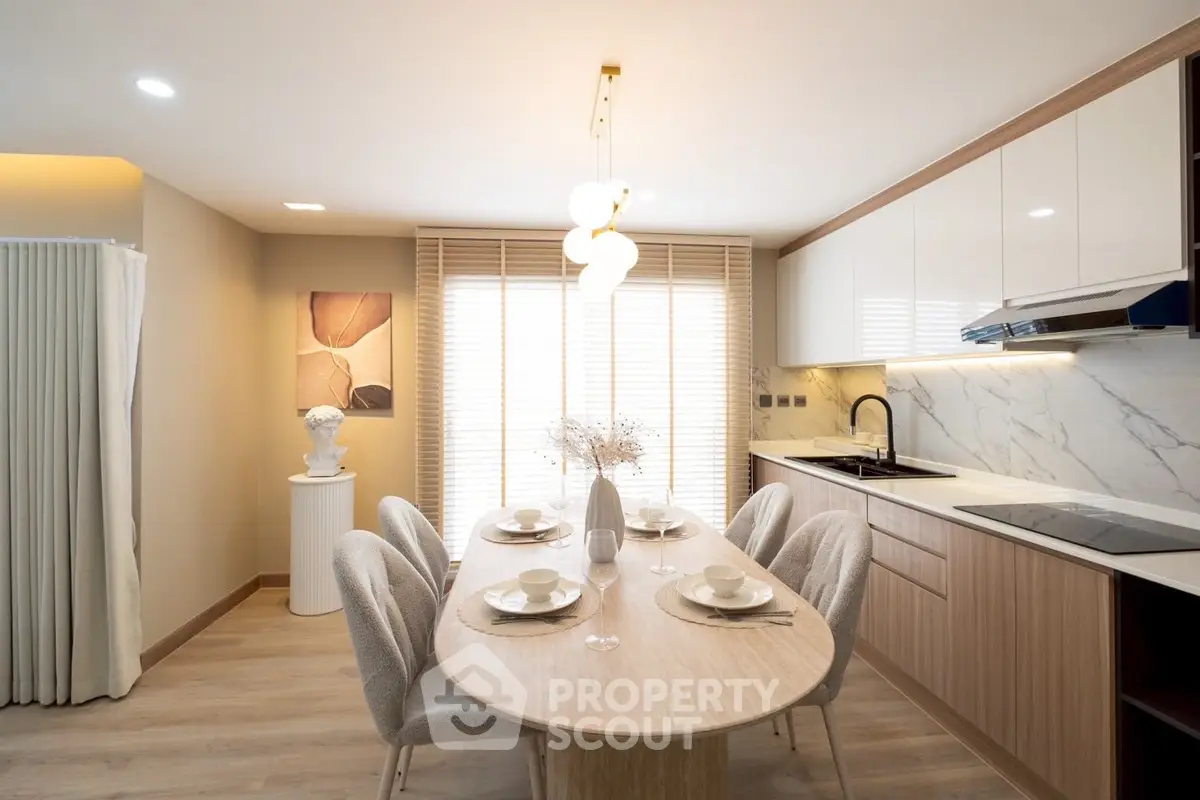 Modern dining area with elegant table setting and stylish kitchen design