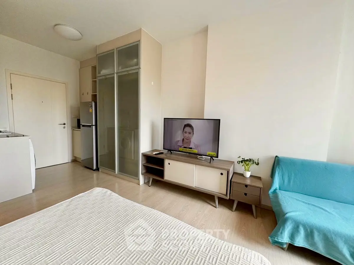 Modern studio apartment with cozy living area and compact kitchen