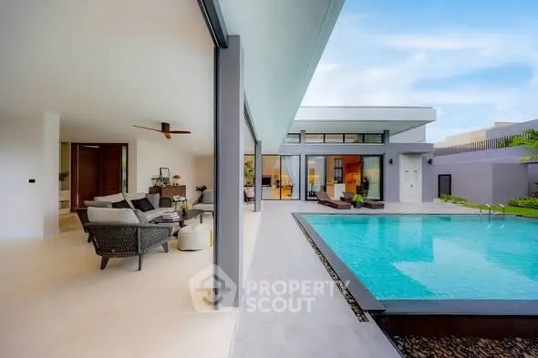 Luxurious modern villa with open living area and private pool, perfect for relaxation and entertainment.