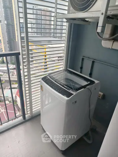 High-rise apartment balcony with washing machine and city view