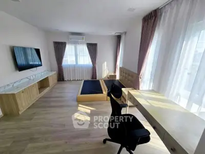 Spacious bedroom with modern furnishings and natural light