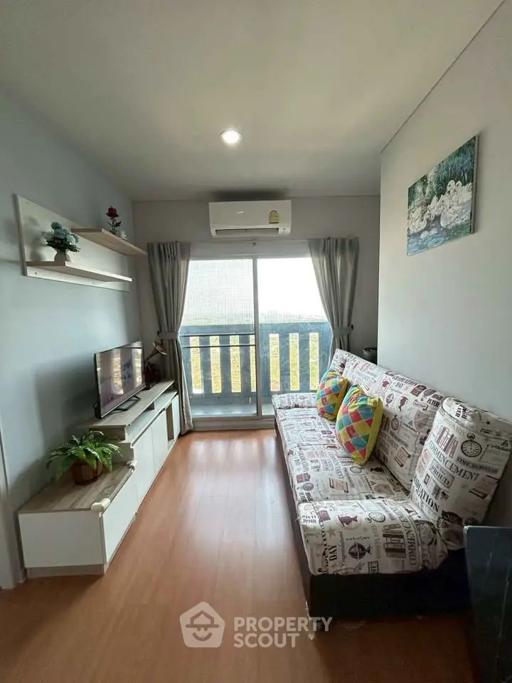 Cozy living room with stylish decor and balcony view, perfect for relaxation and entertainment.