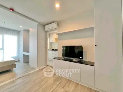 Modern living room with sleek design, featuring built-in storage and air conditioning, perfect for urban living.