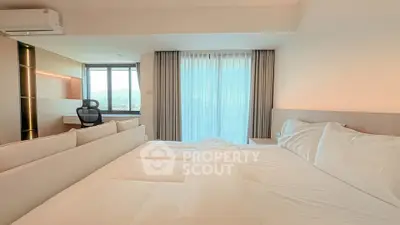 Luxurious bedroom with stunning view and modern workspace, perfect for comfort and productivity.