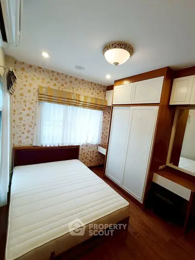 Cozy bedroom with built-in wardrobe and elegant lighting