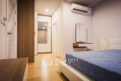 Modern bedroom with wooden flooring and stylish furniture