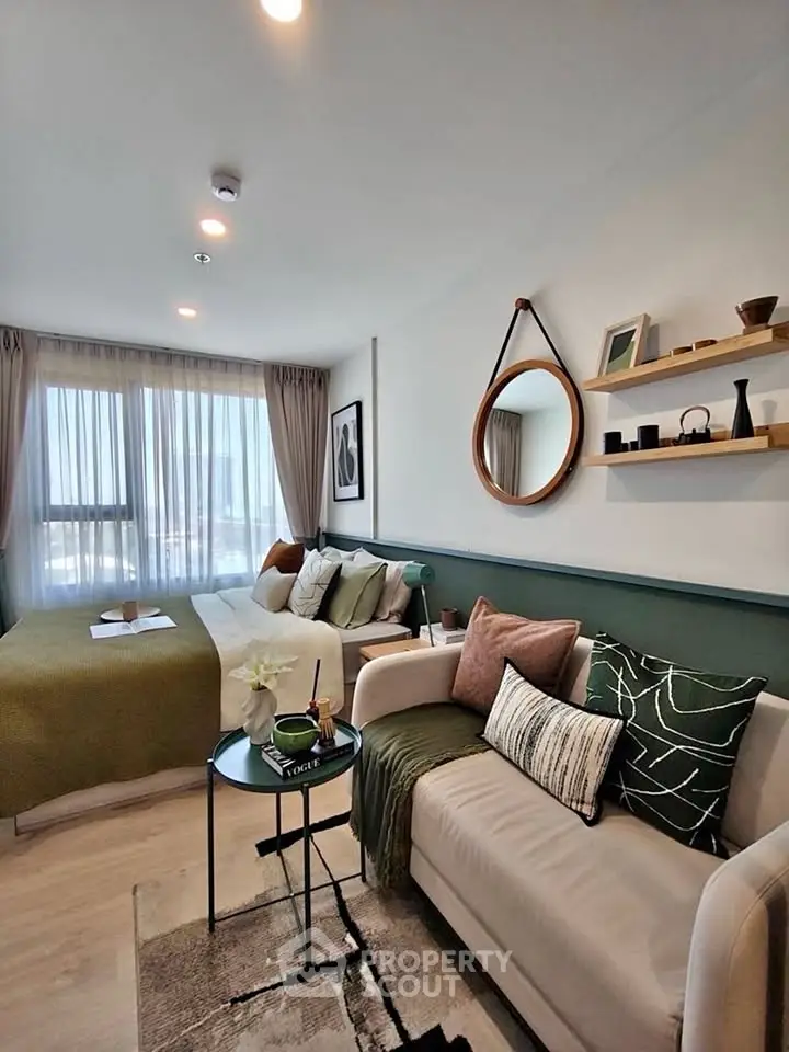 Stylish modern living room with cozy sofa, elegant decor, and natural light from large window.