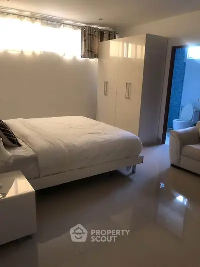 Spacious bedroom with ensuite bathroom and modern furnishings